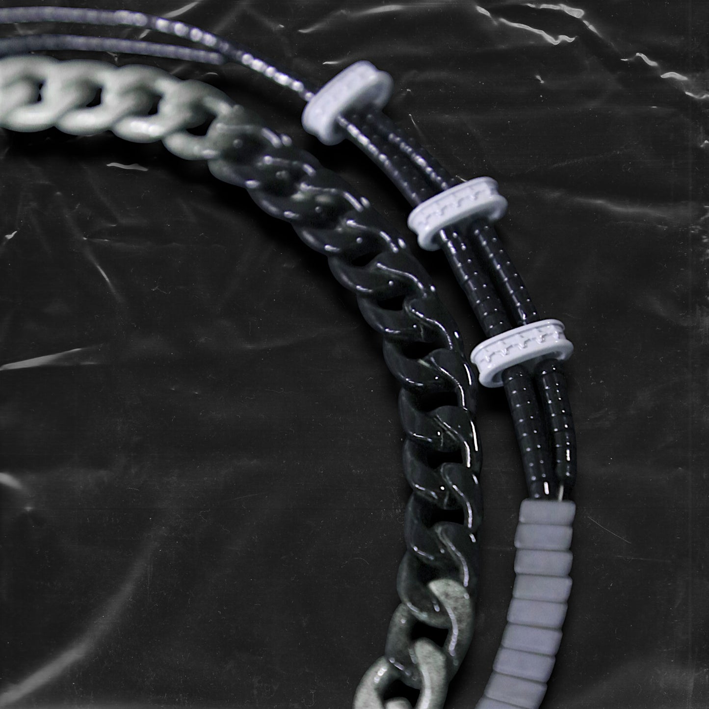 Chockychoker "Chrome Theory" choker featuring a layered structure with a gradient black-to-silver metal chain on the upper tier, and a lower tier composed of black round beads linked by white-grey star-engraved spacers and central matte gradient cube beads. This futuristic accessory channels industrial, cyberpunk, techwear, and alternative streetwear aesthetics. Ideal for unisex fashion, edgy Y2K looks, and bold style statements.