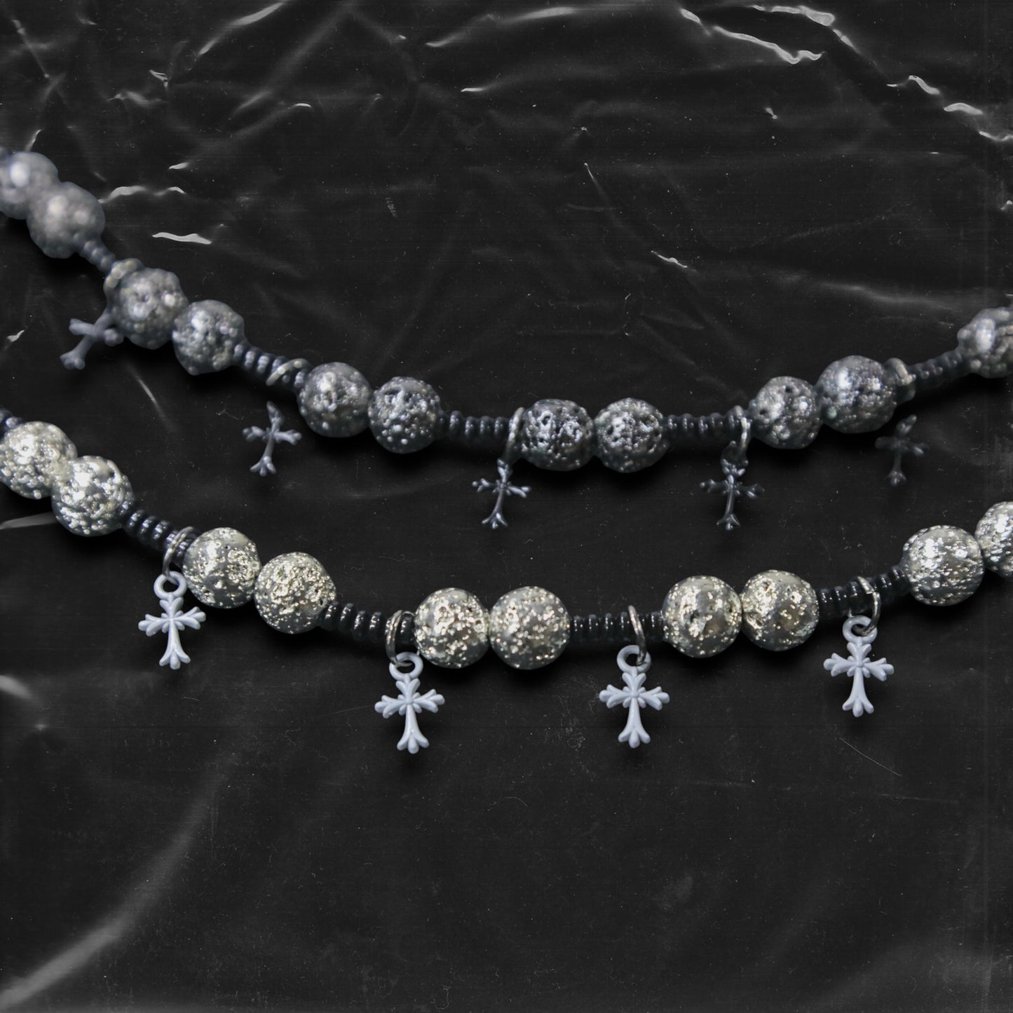 Chockychoker “Nova Chain II ” is a Black gothic choker featuring silver-black alloy beads with a textured, bumpy finish, black plastic cross charms, and black seed beads interwoven as connectors. Ideal for goth, punk, grunge, and alt fashion lovers seeking bold handmade statement jewelry.