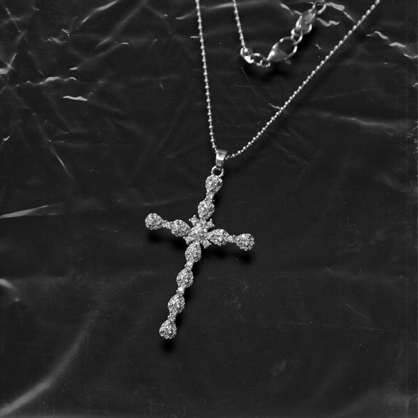 Chockychoker "Vow" necklace featuring a silver fine chain with a sparkling rhinestone cross pendant. A minimalist yet bold piece blending gothic and Y2K aesthetics, perfect for layering or wearing alone.