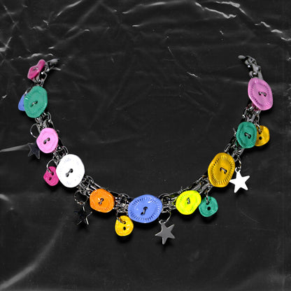 Chockychoker "Button Riot" Choker
 Crafted with a bold silver chain base, this choker is adorned with a playful mix of oversized and small multicolor vintage metal buttons and silver-toned star charms. Like a vibrant button explosion, the design fuses Y2K, gothic kawaii, and playful aesthetics ， perfect for lovers of colorful layering, creative styling, and expressive fashion.