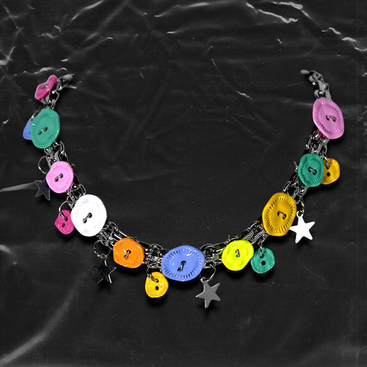 Chockychoker "Button Riot" Choker
 Crafted with a bold silver chain base, this choker is adorned with a playful mix of oversized and small multicolor vintage metal buttons and silver-toned star charms. Like a vibrant button explosion, the design fuses Y2K, gothic kawaii, and playful aesthetics ， perfect for lovers of colorful layering, creative styling, and expressive fashion.