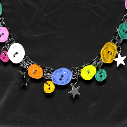 Chockychoker "Button Riot" Choker
 Crafted with a bold silver chain base, this choker is adorned with a playful mix of oversized and small multicolor vintage metal buttons and silver-toned star charms. Like a vibrant button explosion, the design fuses Y2K, gothic kawaii, and playful aesthetics ， perfect for lovers of colorful layering, creative styling, and expressive fashion.