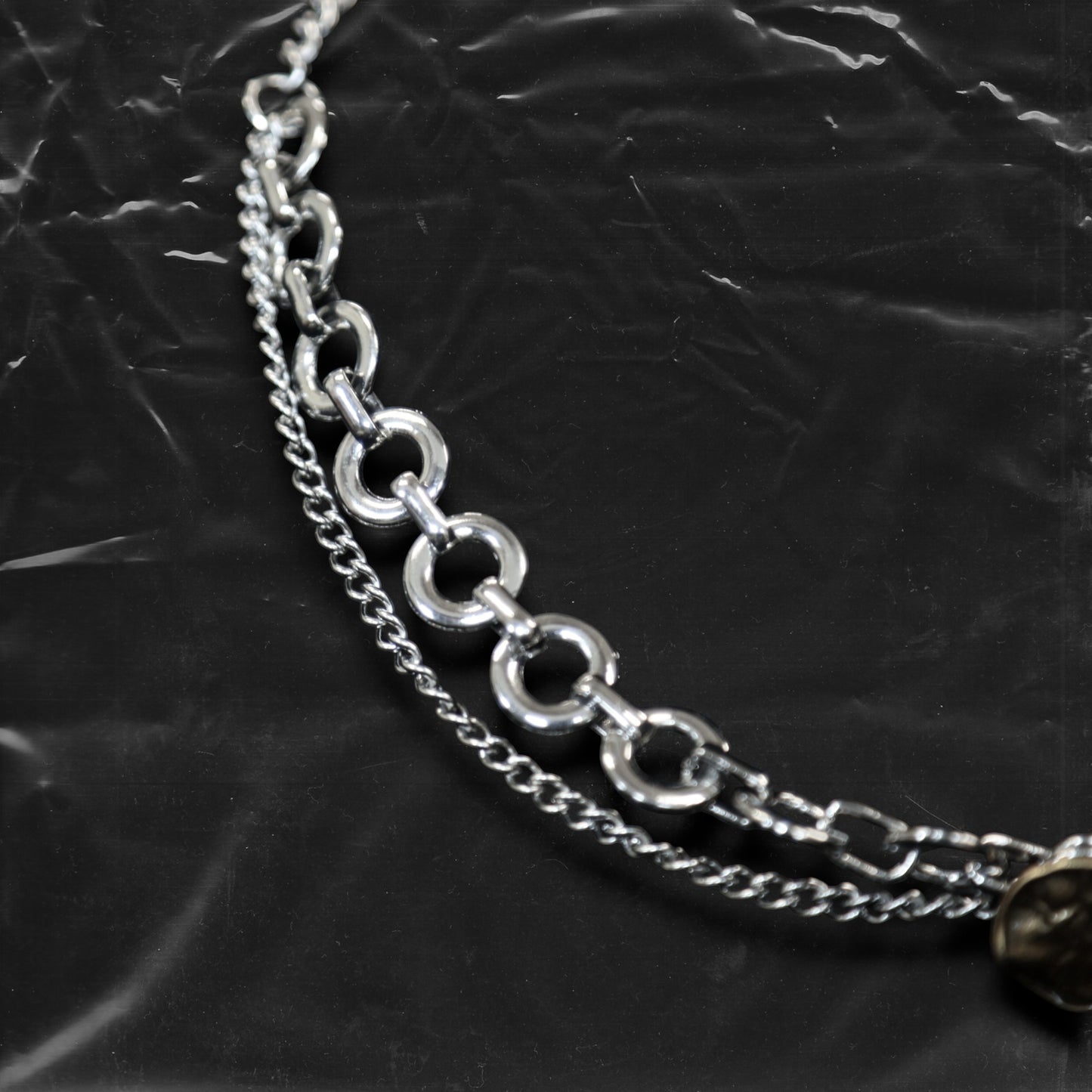 Chockychoker "Dear Item" choker is a silver-based statement piece accented in red, gold, white, and green. It features seal-like silver and gold medallions, a red cross, a green heart charm, faux pearls, vintage-style metallic buttons, a long silver dangling chain, and shell-inspired pieces. Like a wearable collection of curious treasures, this piece blends fantasy, vintage, and Y2K styles—perfect for fairycore, eclectic, and narrative-driven fashion lovers.

