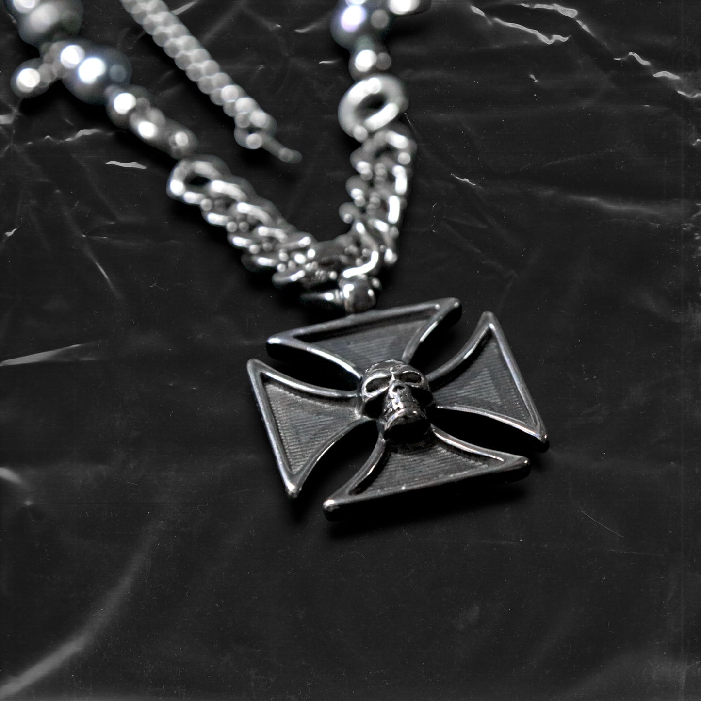 Chockychoker "Knightmare" choker is inspired by the dark knight aesthetic. At its center hangs a black skull-embossed cross pendant, flanked by deep silver and navy-toned metallic pearls intertwined with bold silver chains. The piece embodies a sense of strength and cold elegance, fusing gothic, punk, and Y2K elements. Ideal for those drawn to dark fashion, knightcore fantasy, and layered metallic statement accessories.