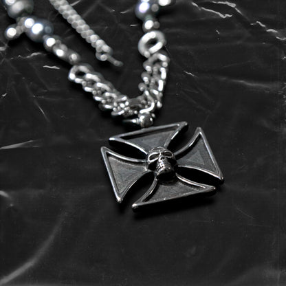 Chockychoker "Knightmare" choker is inspired by the dark knight aesthetic. At its center hangs a black skull-embossed cross pendant, flanked by deep silver and navy-toned metallic pearls intertwined with bold silver chains. The piece embodies a sense of strength and cold elegance, fusing gothic, punk, and Y2K elements. Ideal for those drawn to dark fashion, knightcore fantasy, and layered metallic statement accessories.