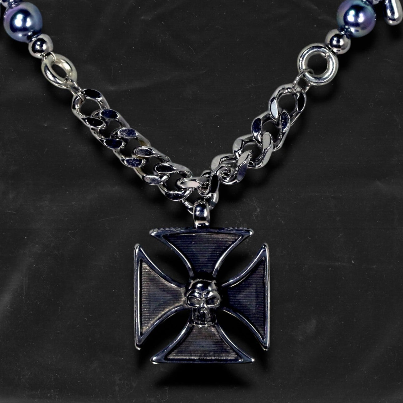 Chockychoker "Knightmare" choker is inspired by the dark knight aesthetic. At its center hangs a black skull-embossed cross pendant, flanked by deep silver and navy-toned metallic pearls intertwined with bold silver chains. The piece embodies a sense of strength and cold elegance, fusing gothic, punk, and Y2K elements. Ideal for those drawn to dark fashion, knightcore fantasy, and layered metallic statement accessories.