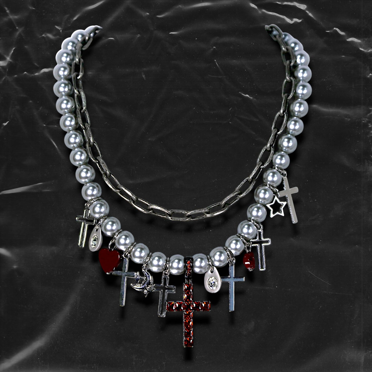 Chockychoker “ Metal Creed ” is a Double-layer choker necklace featuring metallic silver beads and a chunky alloy chain, adorned with a central cross pendant inlaid with sparkling red crystals. Additional charms include alloy cross pendants,  red heart, crescent moon, and hollow star. This statement choker is ideal for gothic, punk, glam-rock, Y2K, and edgy alternative fashion styles.
