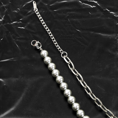 Chockychoker “ Metal Creed ” is a Double-layer choker necklace featuring metallic silver beads and a chunky alloy chain, adorned with a central cross pendant inlaid with sparkling red crystals. Additional charms include alloy cross pendants,  red heart, crescent moon, and hollow star. This statement choker is ideal for gothic, punk, glam-rock, Y2K, and edgy alternative fashion styles.
