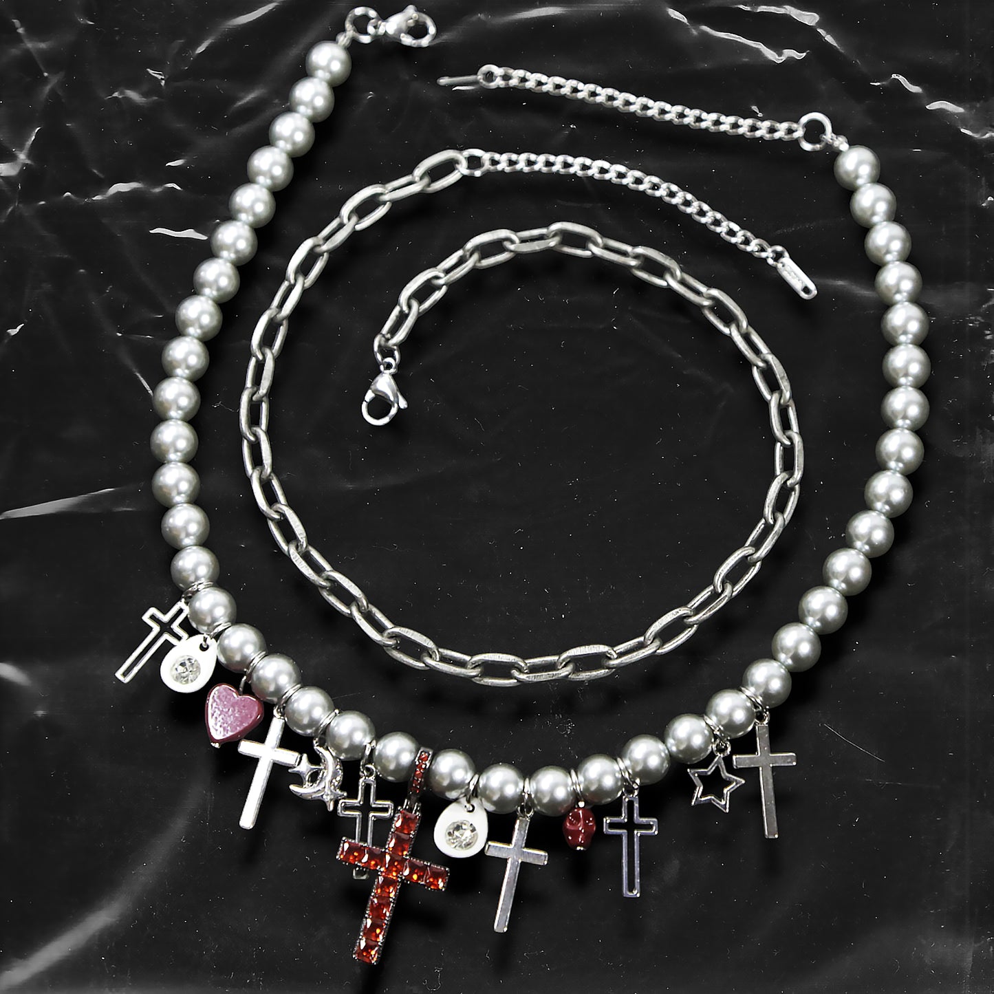 Chockychoker “ Metal Creed ” is a Double-layer choker necklace featuring metallic silver beads and a chunky alloy chain, adorned with a central cross pendant inlaid with sparkling red crystals. Additional charms include alloy cross pendants,  red heart, crescent moon, and hollow star. This statement choker is ideal for gothic, punk, glam-rock, Y2K, and edgy alternative fashion styles.
