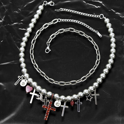 Chockychoker “ Metal Creed ” is a Double-layer choker necklace featuring metallic silver beads and a chunky alloy chain, adorned with a central cross pendant inlaid with sparkling red crystals. Additional charms include alloy cross pendants,  red heart, crescent moon, and hollow star. This statement choker is ideal for gothic, punk, glam-rock, Y2K, and edgy alternative fashion styles.
