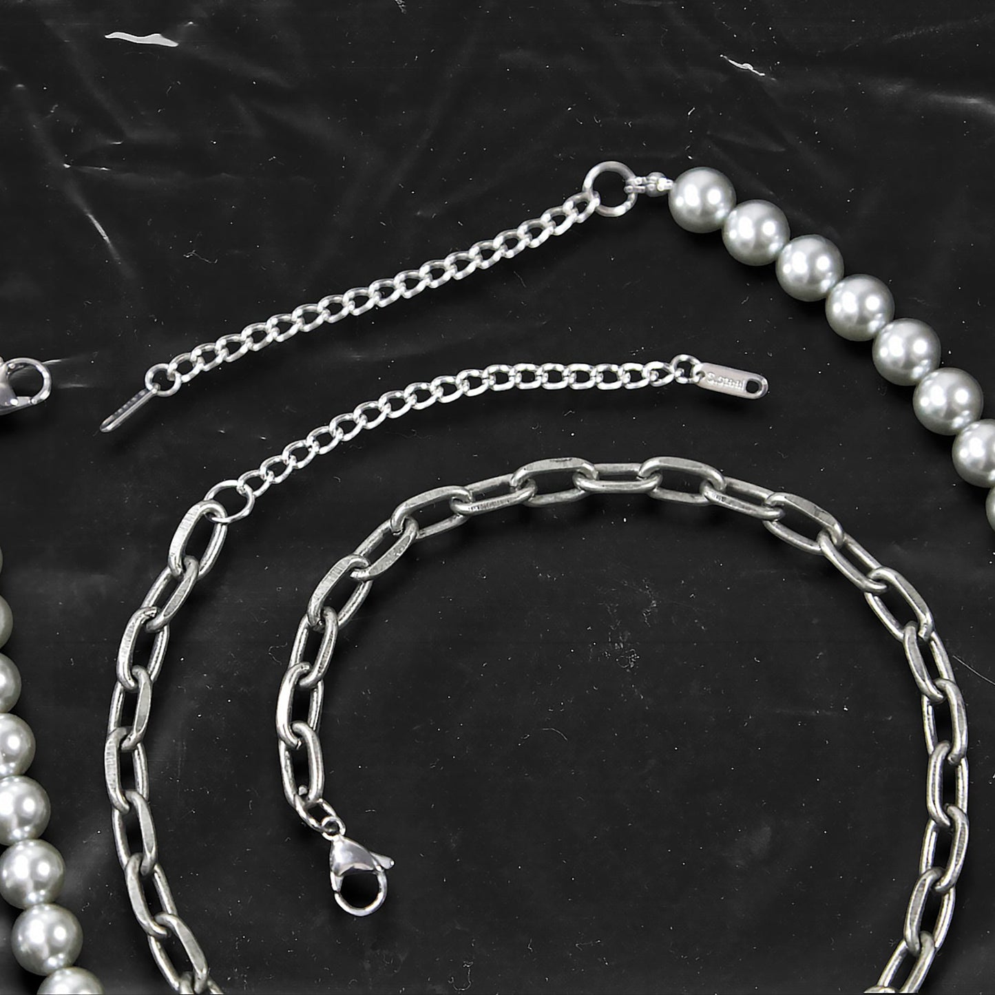 Chockychoker “ Metal Creed ” is a Double-layer choker necklace featuring metallic silver beads and a chunky alloy chain, adorned with a central cross pendant inlaid with sparkling red crystals. Additional charms include alloy cross pendants,  red heart, crescent moon, and hollow star. This statement choker is ideal for gothic, punk, glam-rock, Y2K, and edgy alternative fashion styles.
