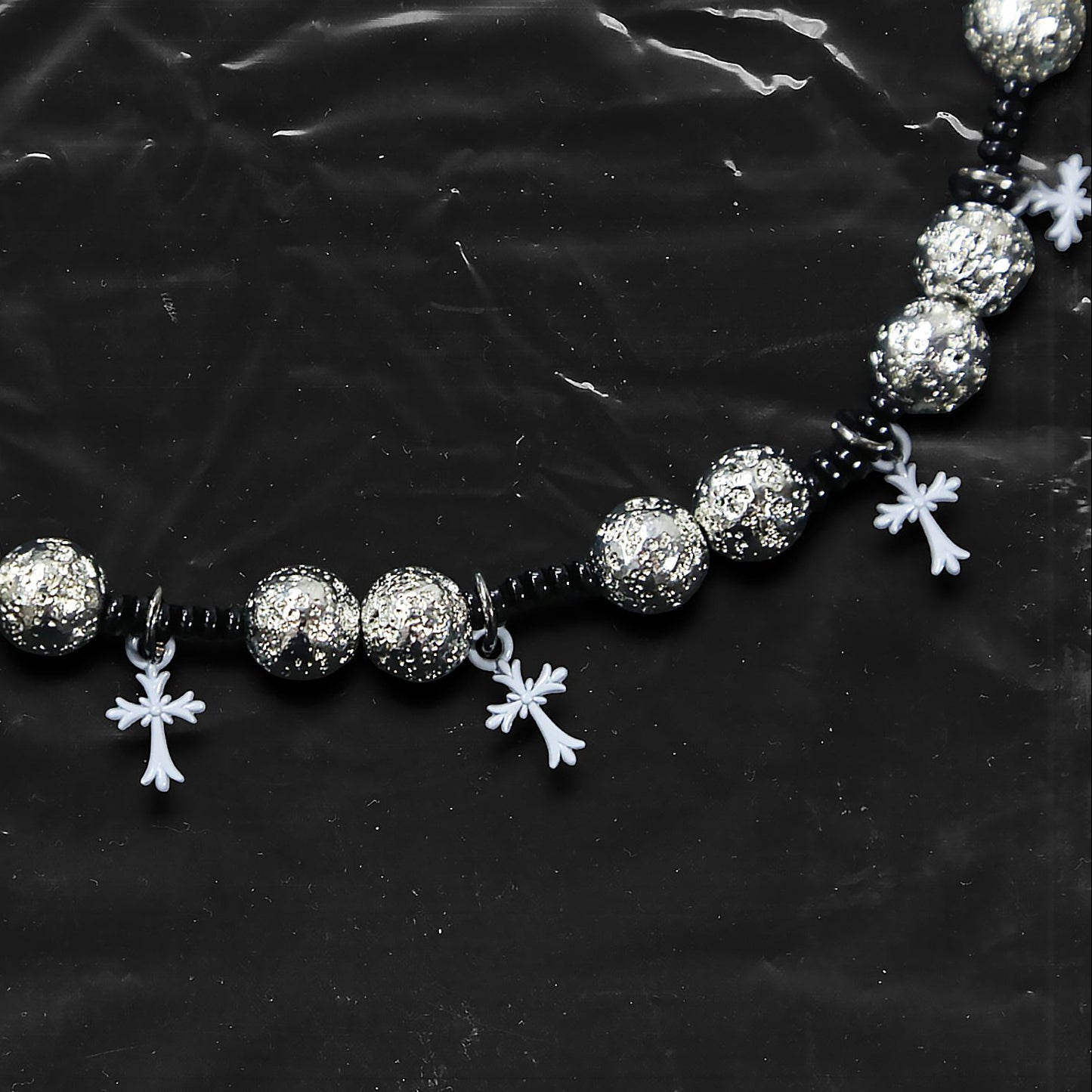 Chockychoker “Nova Chain I” is a Gothic choker necklace featuring white plastic cross charms and silver textured alloy beads, strung with black seed beads. Perfect for alternative, Y2K, punk, goth, and edgy fashion lovers. Statement unisex accessory with dark aesthetic and industrial vibe.
