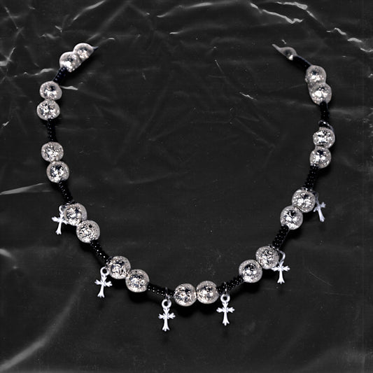 Chockychoker “Nova Chain I” is a Gothic choker necklace featuring white plastic cross charms and silver textured alloy beads, strung with black seed beads. Perfect for alternative, Y2K, punk, goth, and edgy fashion lovers. Statement unisex accessory with dark aesthetic and industrial vibe.
