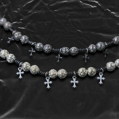 Chockychoker “Nova Chain II ” is a Black gothic choker featuring silver-black alloy beads with a textured, bumpy finish, black plastic cross charms, and black seed beads interwoven as connectors. Ideal for goth, punk, grunge, and alt fashion lovers seeking bold handmade statement jewelry.
