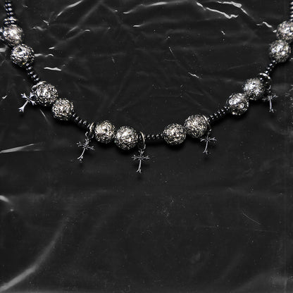 Chockychoker “Nova Chain II ” is a Black gothic choker featuring silver-black alloy beads with a textured, bumpy finish, black plastic cross charms, and black seed beads interwoven as connectors. Ideal for goth, punk, grunge, and alt fashion lovers seeking bold handmade statement jewelry.
