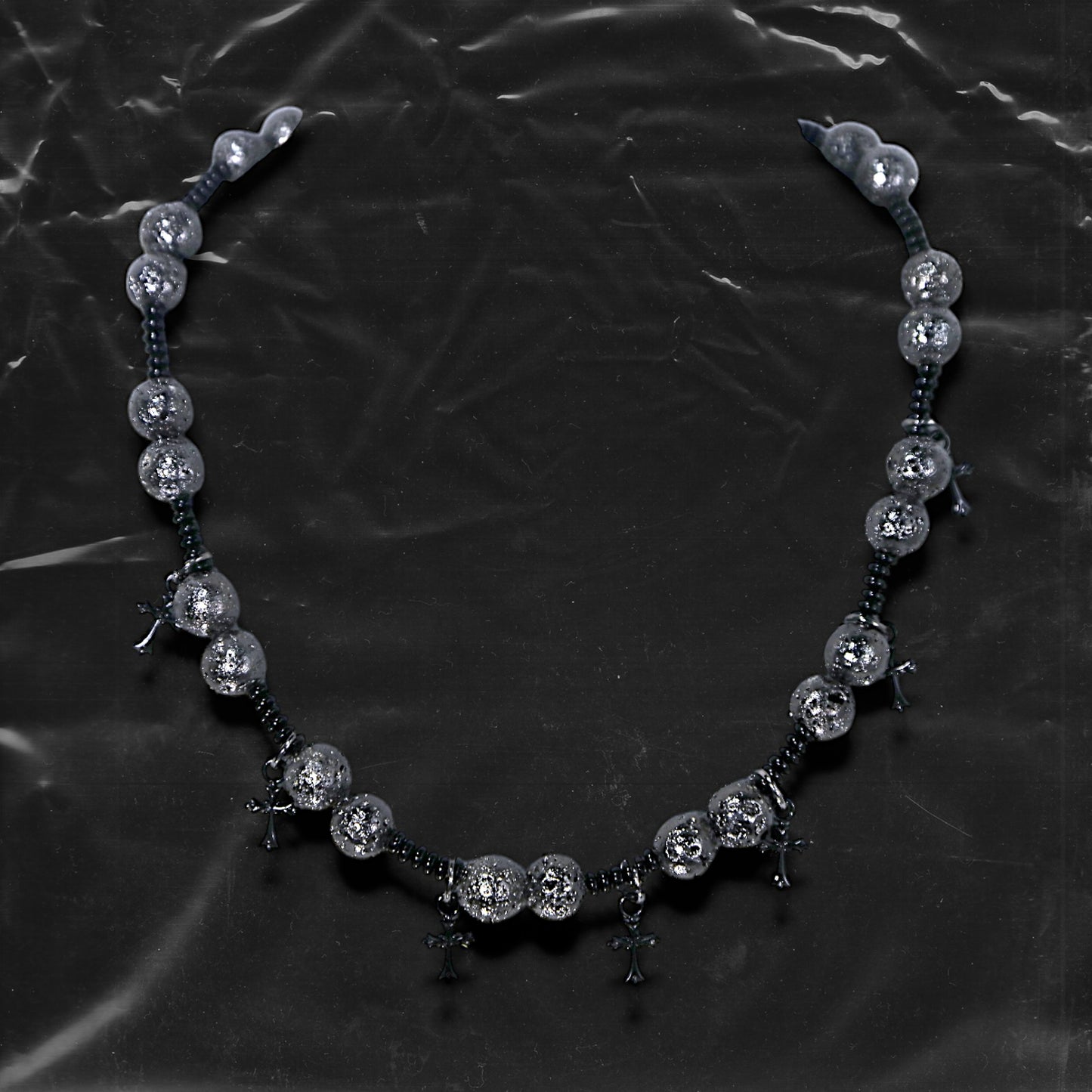 Chockychoker “Nova Chain II ” is a Black gothic choker featuring silver-black alloy beads with a textured, bumpy finish, black plastic cross charms, and black seed beads interwoven as connectors. Ideal for goth, punk, grunge, and alt fashion lovers seeking bold handmade statement jewelry.
