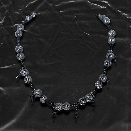 Chockychoker “Nova Chain II ” is a Black gothic choker featuring silver-black alloy beads with a textured, bumpy finish, black plastic cross charms, and black seed beads interwoven as connectors. Ideal for goth, punk, grunge, and alt fashion lovers seeking bold handmade statement jewelry.
