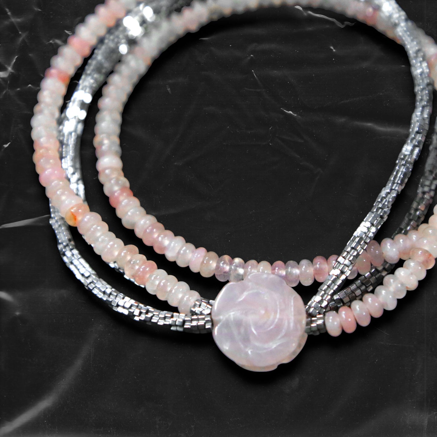 Chockychoker's “Rosé Whisper” is a handcrafted double-layer choker featuring soft pink rounded beads paired with faceted silver-tone glass beads. A delicately carved pale pink rose charm accents the left side, adding a touch of romantic flair. The color palette blends baby pink and silvery grey,  Perfect for styles like soft punk, balletcore, romantic Y2K, mellow tone , and Japanese commuter looks. Whether layered for a casual vibe or worn as a standout accessory for dressy or feminine outfits
