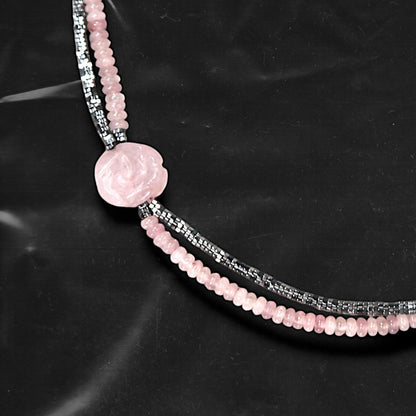 Chockychoker's “Rosé Whisper” is a handcrafted double-layer choker featuring soft pink rounded beads paired with faceted silver-tone glass beads. A delicately carved pale pink rose charm accents the left side, adding a touch of romantic flair. The color palette blends baby pink and silvery grey,  Perfect for styles like soft punk, balletcore, romantic Y2K, mellow tone , and Japanese commuter looks. Whether layered for a casual vibe or worn as a standout accessory for dressy or feminine outfits

