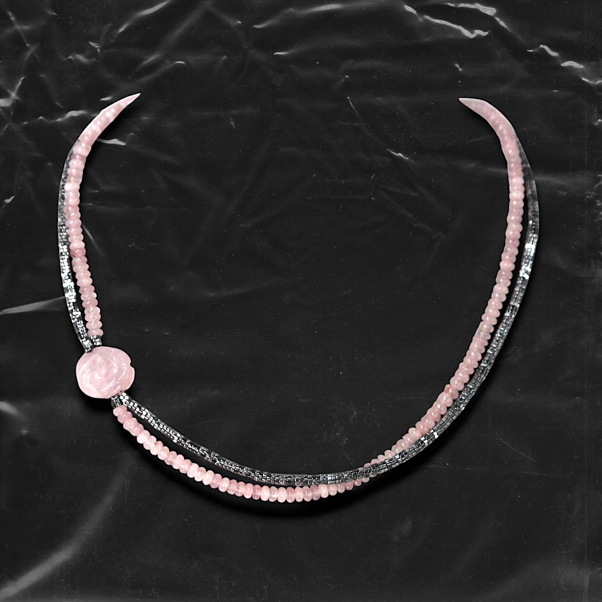 Chockychoker's “Rosé Whisper” is a handcrafted double-layer choker featuring soft pink rounded beads paired with faceted silver-tone glass beads. A delicately carved pale pink rose charm accents the left side, adding a touch of romantic flair. The color palette blends baby pink and silvery grey,  Perfect for styles like soft punk, balletcore, romantic Y2K, mellow tone , and Japanese commuter looks. Whether layered for a casual vibe or worn as a standout accessory for dressy or feminine outfits
