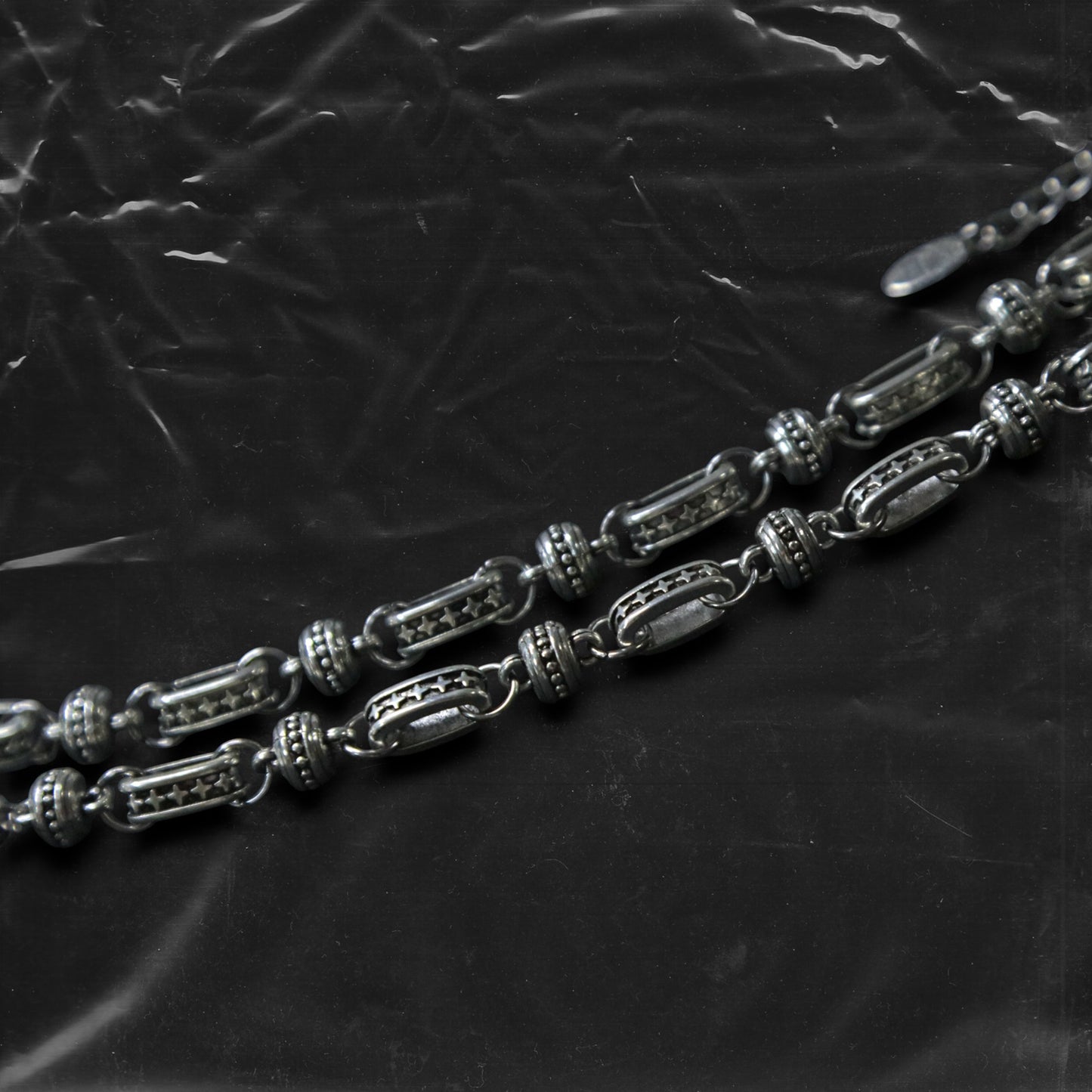The Chockychoker “Stellar Orbit” necklace features alternating elliptical hollow beads and silver connectors engraved with star motifs, forming a celestial, orbital arrangement. The design exudes a strong sense of futurism and cosmic energy, perfect for styling in spacecore, Y2K, minimalist, and galaxy-inspired fashion aesthetics.

