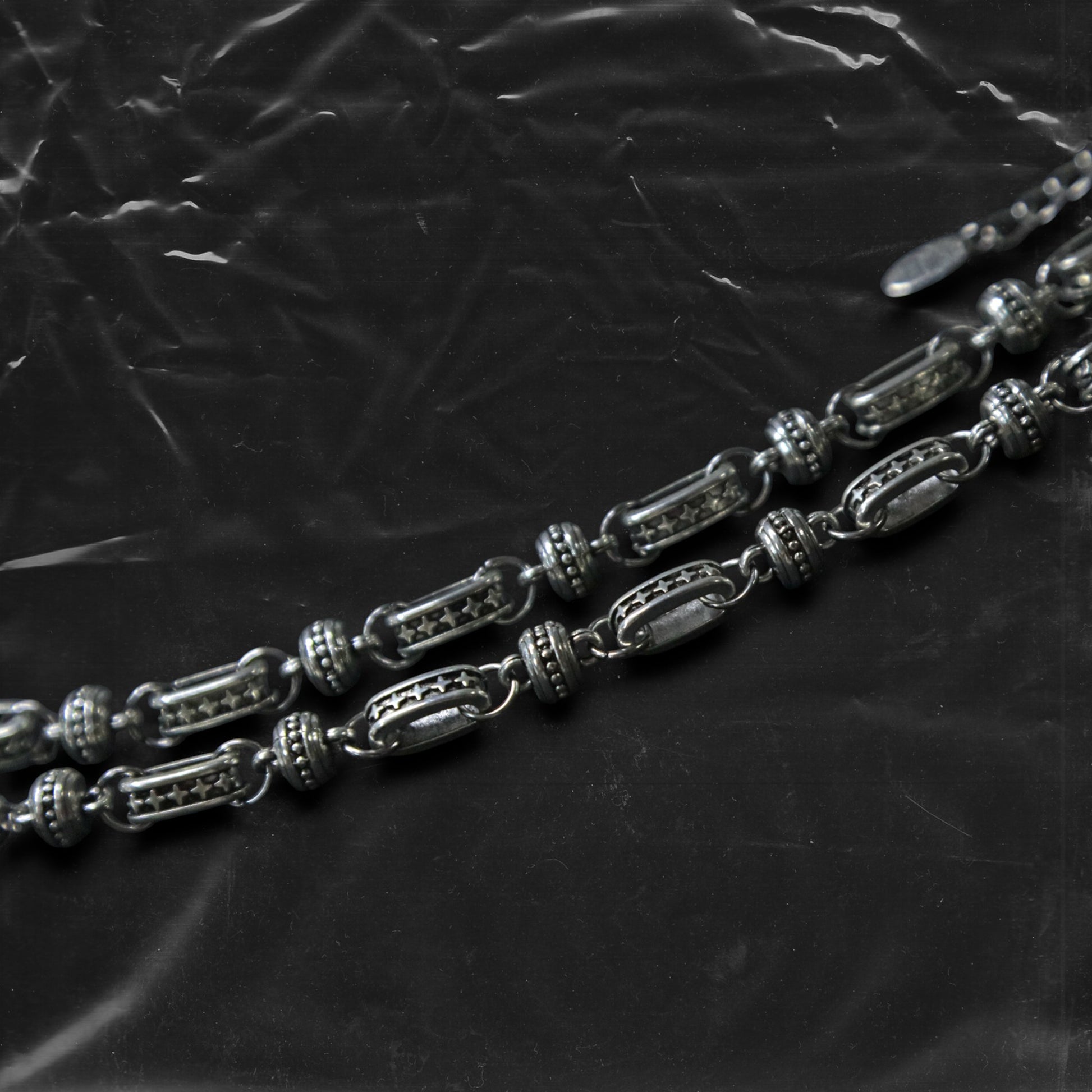 The Chockychoker “Stellar Orbit” necklace features alternating elliptical hollow beads and silver connectors engraved with star motifs, forming a celestial, orbital arrangement. The design exudes a strong sense of futurism and cosmic energy, perfect for styling in spacecore, Y2K, minimalist, and galaxy-inspired fashion aesthetics.
