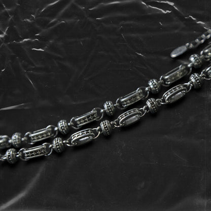 The Chockychoker “Stellar Orbit” necklace features alternating elliptical hollow beads and silver connectors engraved with star motifs, forming a celestial, orbital arrangement. The design exudes a strong sense of futurism and cosmic energy, perfect for styling in spacecore, Y2K, minimalist, and galaxy-inspired fashion aesthetics.
