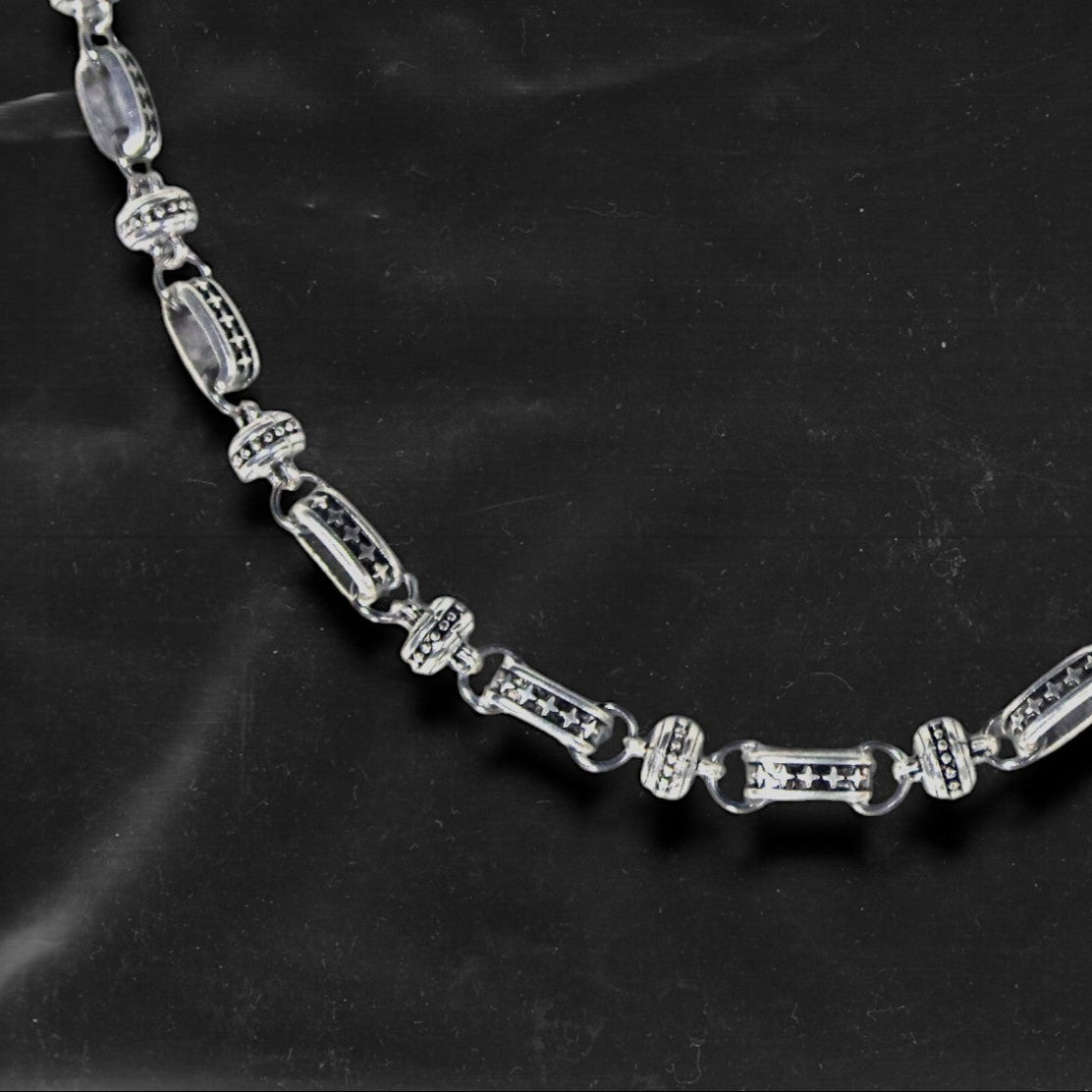 The Chockychoker “Stellar Orbit” necklace features alternating elliptical hollow beads and silver connectors engraved with star motifs, forming a celestial, orbital arrangement. The design exudes a strong sense of futurism and cosmic energy, perfect for styling in spacecore, Y2K, minimalist, and galaxy-inspired fashion aesthetics.
