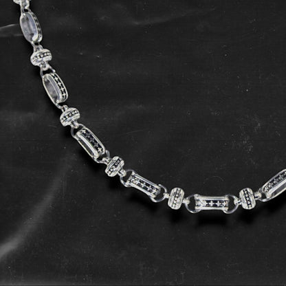 The Chockychoker “Stellar Orbit” necklace features alternating elliptical hollow beads and silver connectors engraved with star motifs, forming a celestial, orbital arrangement. The design exudes a strong sense of futurism and cosmic energy, perfect for styling in spacecore, Y2K, minimalist, and galaxy-inspired fashion aesthetics.
