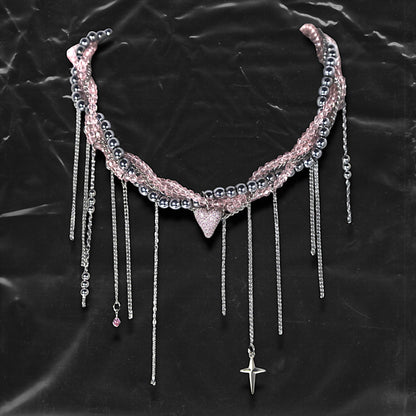 Chockychoker “ Sugarglow ” is a Double-layer twisted choker combining pink knit yarn and metallic silver alloy beads, adorned with a central heart-shaped charm inlaid with pink crystals. The necklace features dangling silver chains, transparent pink crystal drops, and a single star charm, evoking both sweetcore and edgy glam aesthetics. Perfect for lovers of Y2K revival, coquette fashion, Harajuku streetwear, Materials include silver-tone alloy, faux crystals, acrylic yarn, and metal chains.