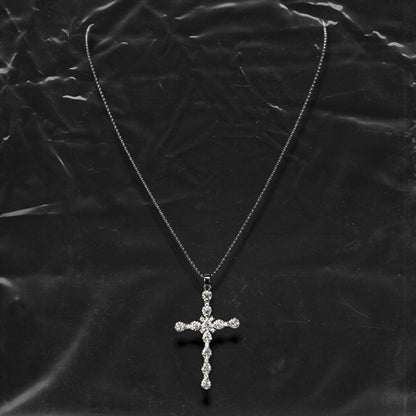 Chockychoker "Vow" necklace featuring a silver fine chain with a sparkling rhinestone cross pendant. A minimalist yet bold piece blending gothic and Y2K aesthetics, perfect for layering or wearing alone.


