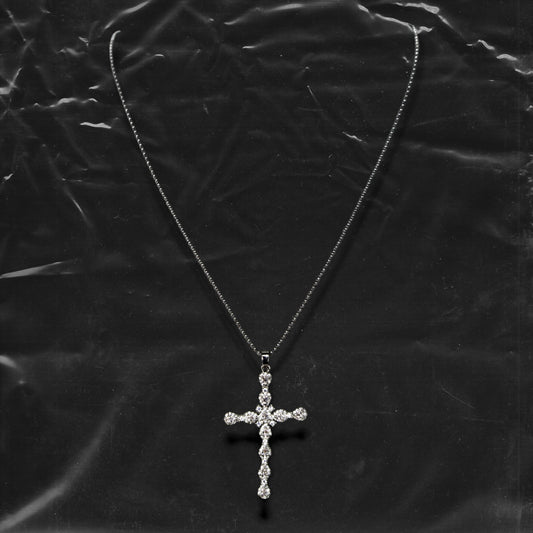 Chockychoker "Vow" necklace featuring a silver fine chain with a sparkling rhinestone cross pendant. A minimalist yet bold piece blending gothic and Y2K aesthetics, perfect for layering or wearing alone.

