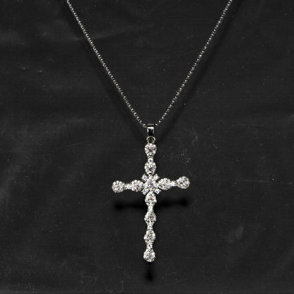 Chockychoker "Vow" necklace featuring a silver fine chain with a sparkling rhinestone cross pendant. A minimalist yet bold piece blending gothic and Y2K aesthetics, perfect for layering or wearing alone.

