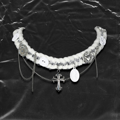 Chockychoker “Milk Galaxy” is a Handcrafted gothic-style choker made from soft white yarn interwoven with shimmering silver thread, adorned with layered silver-tone chains, a central baroque-style silver cross pendant, a mix of glossy white plastic buttons and vintage-style metallic buttons, and white oval resin charms ideal for lovers of gothic, alt, punk, lolita, soft grunge, and romantic street fashion. Perfect for those seeking statement chokers with unique handcrafted details and mixed media textures.